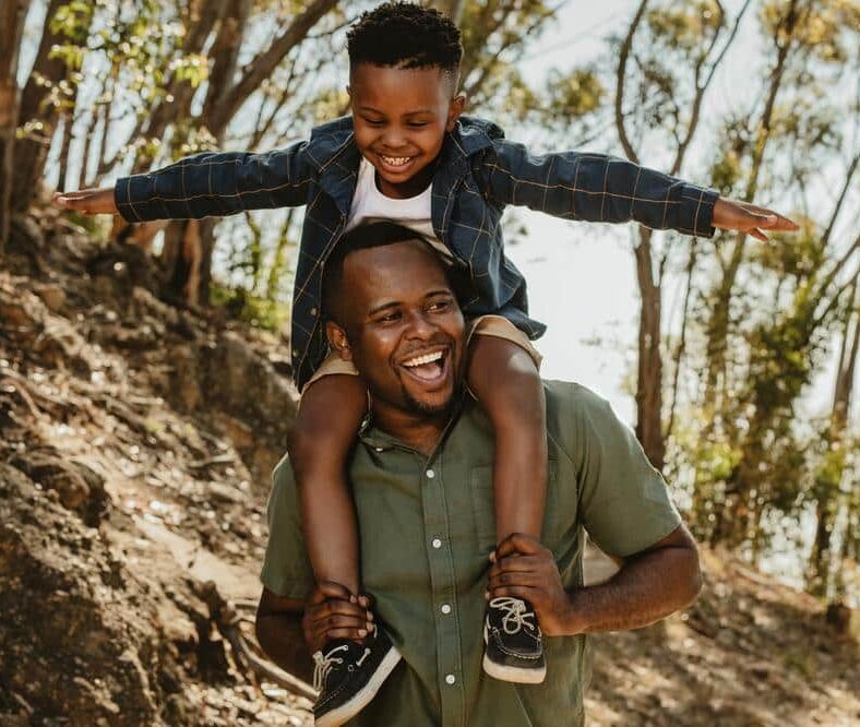 Father-son-laughing-outside-healthy-smiles Our dental office