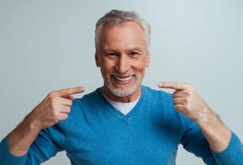 Smiling-man-dentures-new-smile Dentures