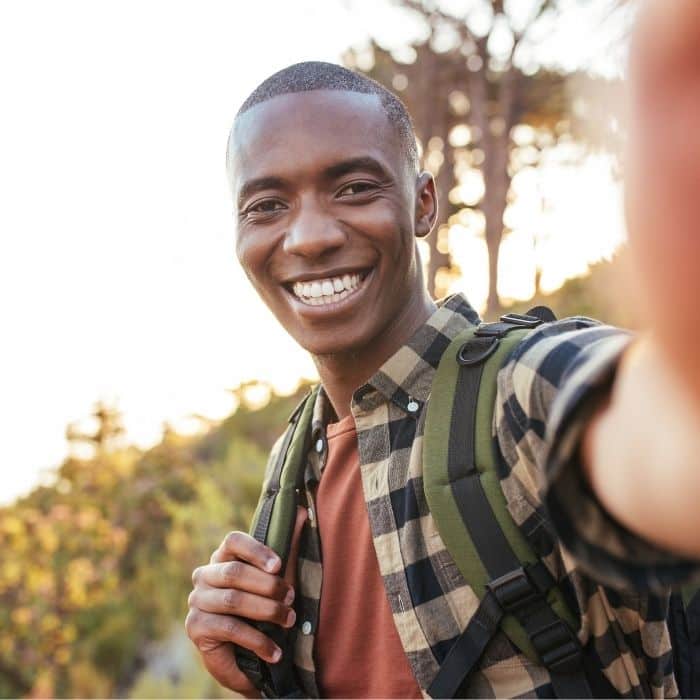 Smiling-man-hiking-bright-smile-white-teeth Smiling man hiking bright smile white teeth