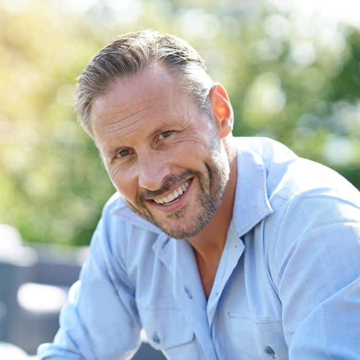 Smiling-man-outside-healthy-teeth-happy Dental crowns